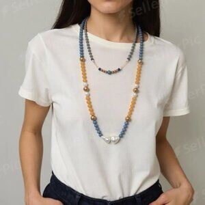 Sun and sky. Colors of blue/yellow/white.  Long beaded and choker. Two complimen